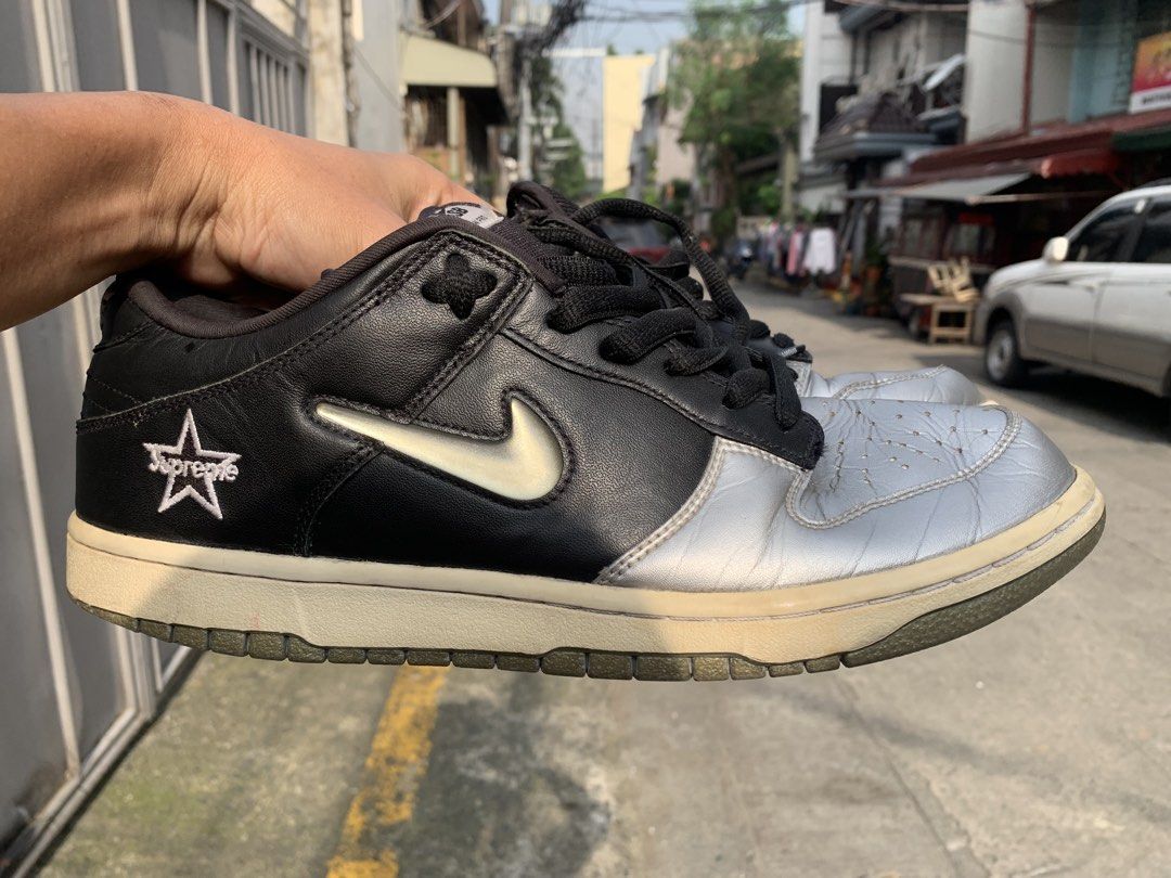 Nike SB Dunk Low Pro Supreme Black Silver (Category: Sneakers) located in Manila. Submitted by aris_bantug_complex (Listing ID 1451955715, Image 3). Description: - Supreme x Nike SB Dunk Low Pro - Colorway: Black and Silver - Iconic Supreme star logo on the side - Laces feature 'Famous World' text - Classic skate shoe design .