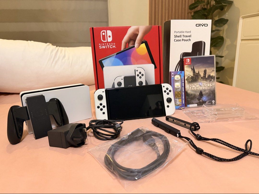 Nintendo Switch Oled (with extras) (Category: Nintendo) located in Manila. Submitted by rishaelysse (Listing ID 1452064519, Image 2). Description: Nintendo Switch Oled White - Like new - Complete with all original accessories and box Comes with: - Screen Protector - 128GB SD card - Clear Case - Portable Hard Shell Case Pouch - Hogwarts Legacy Game Chip - Harry Potter inspired Silicone Button Caps MOP: GCash or Bank transfer No COD.