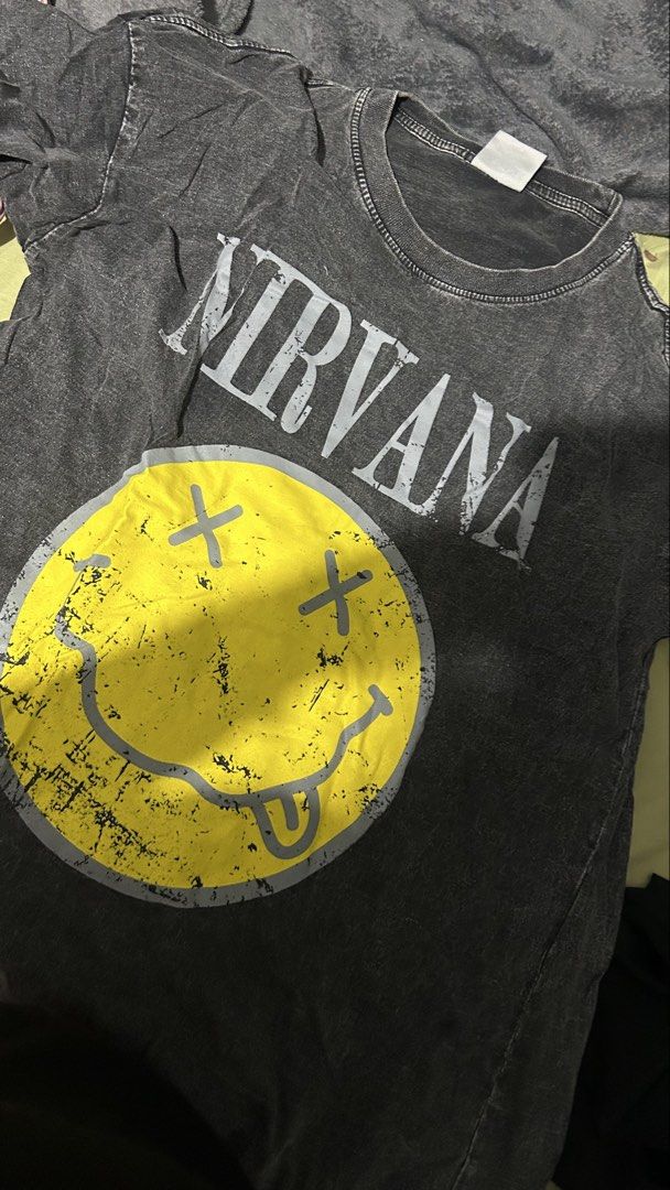 Nirvana Smiley Face Graphic T-Shirt (Category: Tshirts & Polo Shirts ) located in Marikina City. Submitted by chartan15 (Listing ID 1452029491, Image 2). Description: - Grey Nirvana t-shirt - Iconic smiley face graphic - Acid wash style - Made in Thailand - Ideal for any Nirvana fan.
