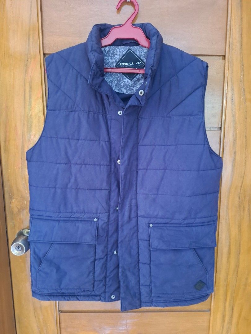 O'Neill Puffer Vest Navy Blue (Category: Vests) located in Legazpi City. Submitted by thriftrow (Listing ID 1451951932, Image 1). Description: - Navy blue O'Neill puffer vest - Quilted design - Button-up front - Two chest pockets - Two side pockets - Patterned fabric lining - Ideal for layering.