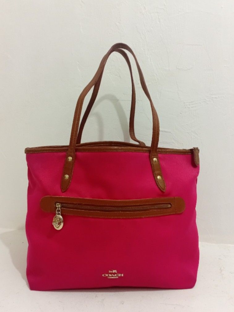 Original Coach SAWYER Tote Bag (Category: Luxury Bags & Wallets) located in Manila. Submitted by eriiicaspage (Listing ID 1434939623, Image 1). Description: PreOwned WellUsed Coach Sawyer tote bag - Vibrant pink exterior - Brown leather accents - Zip closure - Dual top handles - Small Coach logo - Brown base - Medium size Sign of Used flaws : Sign of Used sa innerlining ,May ilang Part na Sticky sa leather Strap Good Condition 8.8/10 - Ideal for 