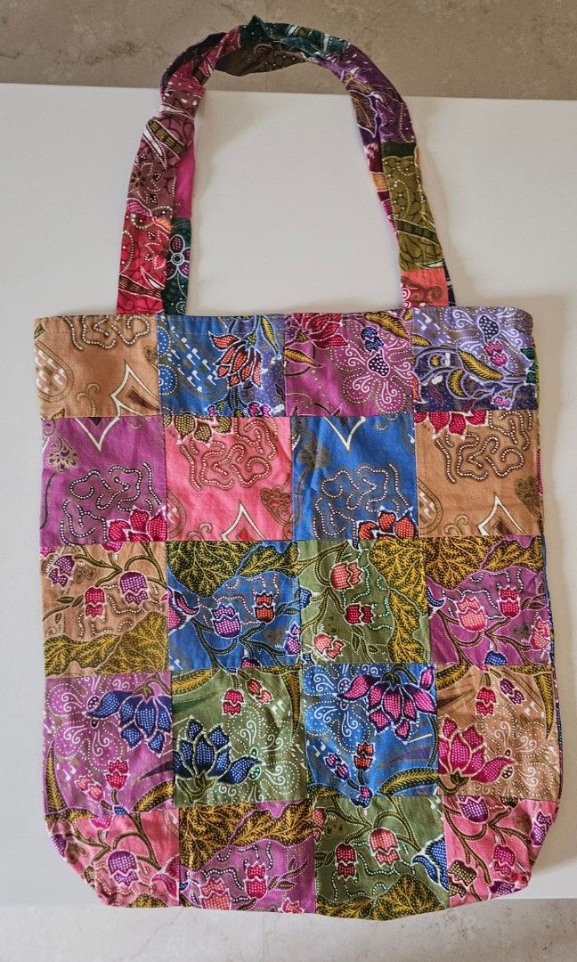 Patchwork Batik Tote Bag (Category: Tote Bags) located in Singapore. Submitted by rapuser2006 (Listing ID 1451917518, Image 1). Description: - Handmade tote bag - Unique colorful patchwork batik design - Vibrant floral fabric - Sturdy handles - Simple interior - Ideal for everyday use or as a statement accessory - Approximate dimensions: 15" (width) x 14" (height).