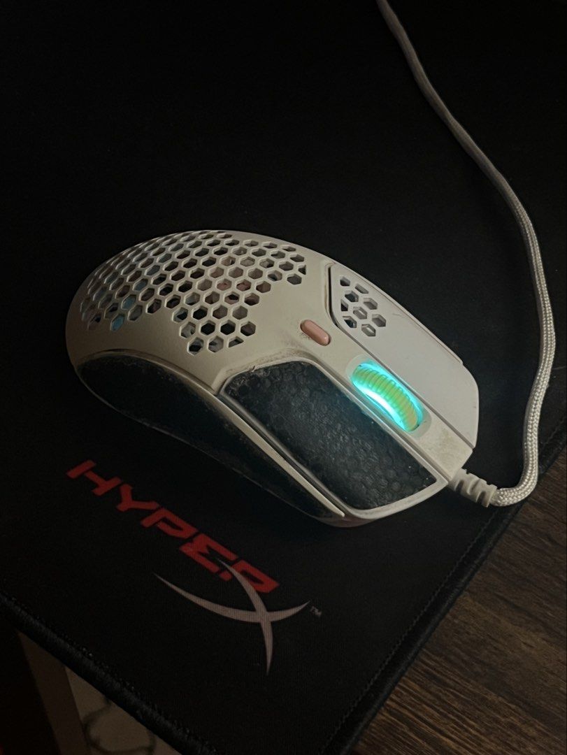 (Pink & White) HyperX Pulsefire Haste Gaming Mouse White Pink (Category: Mouse & Mousepads) located in Makati City. Submitted by belladonna.ph_ (Listing ID 1452053736, Image 2). Description: White & pink 🩷🎀 HyperX Pulsefire Haste gaming mouse! Lightweight honeycomb design, RGB scroll wheel. Minor signs of wear, works perfectly. The black thing on it is grip pad provided by HyperX, comes with the mouse. Will be removed and cleaned upon request. 