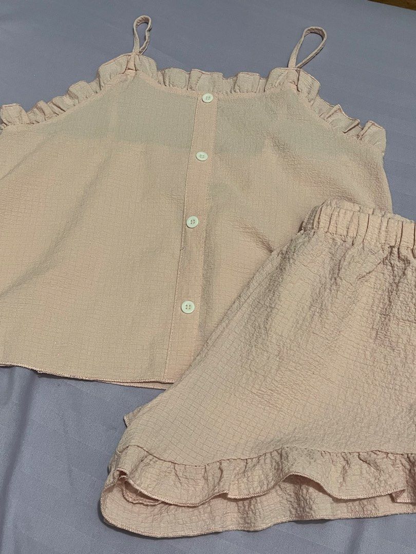 Pink Ruffled Pajama Set with Buttons (Category: Undergarments & Loungewear) located in Manila. Submitted by acbdacbd (Listing ID 1452073132, Image 1). Description: - Adorable pink pajama set - Top features ruffled edges and button details - Shorts have an elastic waistband and ruffled hem - Made with comfortable, textured fabric - Ideal for cozy nights in, lounging, or sleeping.