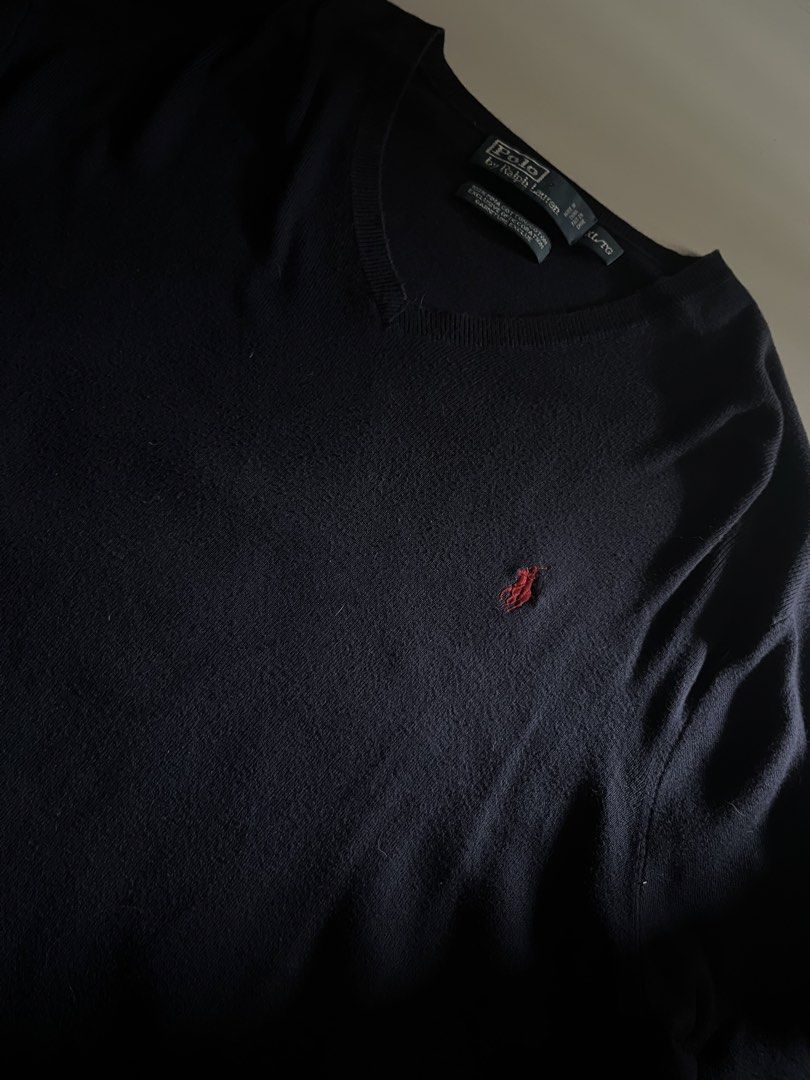 Polo Ralph Lauren Knitted Sweatee (Category: Luxury Apparel) located in Santa Ana. Submitted by rlave (Listing ID 1452002236, Image 2). Description: Preloved Polo Ralph Lauren black V-neck sweater, size XL, oversized fit. Features the embroidered Polo Pony logo in red on the chest, 100% Pima cotton construction, ribbed V-neck collar and cuffs — great for a relaxed, oversized streetwear look or everyday layering. Item is in good preloved condition