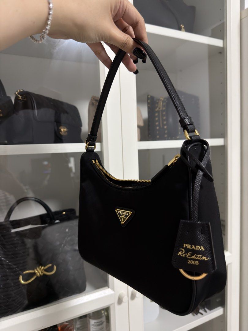 Prada Re-Edition 2005 Nylon Shoulder Bag Black (Category: Luxury Bags & Wallets) located in Manila. Submitted by marj_yyy (Listing ID 1452025011, Image 2). Description: - Authentic from Prada Greenbelt - With receipt - Complete with box, dust bag, and paper bag - RFS: wants to buy a new bag 😂 - Rarely used .
