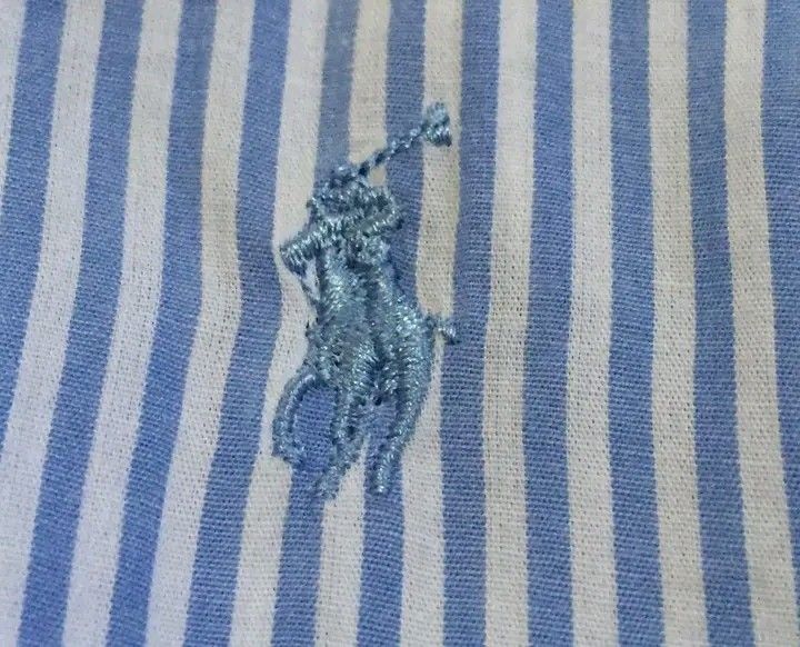 Ralph Lauren Blue Striped Button Down Shirt Size S (Category: Tshirts & Polo Shirts ) located in Calbayog City. Submitted by taking-candy.ph (Listing ID 1451938836, Image 3). Description: - Classic blue and white pinstripe button-down shirt - Brand: Ralph Lauren - Iconic embroidered polo player logo on chest - Subtle floral print on collar and inner placket - Size: S - Made in India.