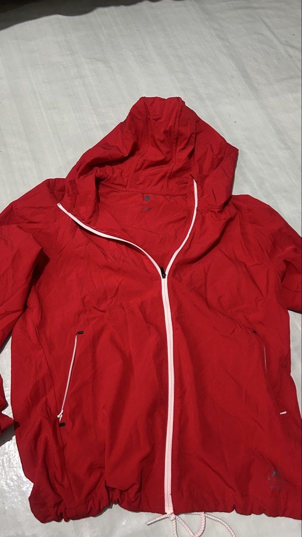 Red Hooded Windbreaker Jacket (Category: Activewear) located in Marikina City. Submitted by chartan15 (Listing ID 1452003014, Image 2). Description: - Lightweight red jacket - Attached hood - Full zip front with white accents - Drawstring hem for adjustable fit - Two zippered side pockets - Ideal for outdoor activities, layering, and travel.
