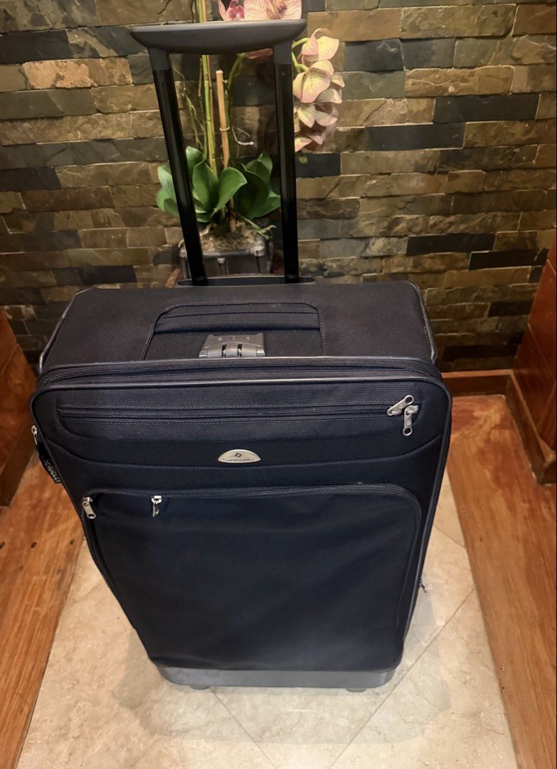 Samsonite Navy Blue Softside Spinner Luggage (Category: Luggage) located in Pasig City. Submitted by danbrit_sells (Listing ID 1452072269, Image 2). Description: - Navy blue Samsonite spinner luggage - Built-in TSA lock for security - Clean interior with straps and zippered compartment - Exterior has minor scuffs on bottom and corners (normal travel wear) - Wheels roll smoothly - Telescopic handle extends and retracts easily - Perfect for your up