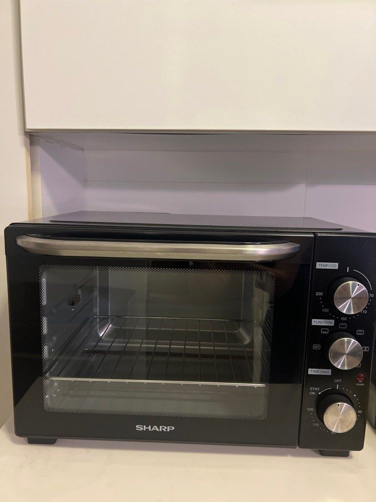 Sharp Oven (Category: Ovens & Toasters) located in Singapore. Submitted by sparkingjoy.reducereuserecycle (Listing ID 1452033052, Image 1). Description: - Sharp oven with sleek black exterior - Multiple function settings - Temperature control up to 230°C - Built-in timer function - Perfect for baking and roasting needs.