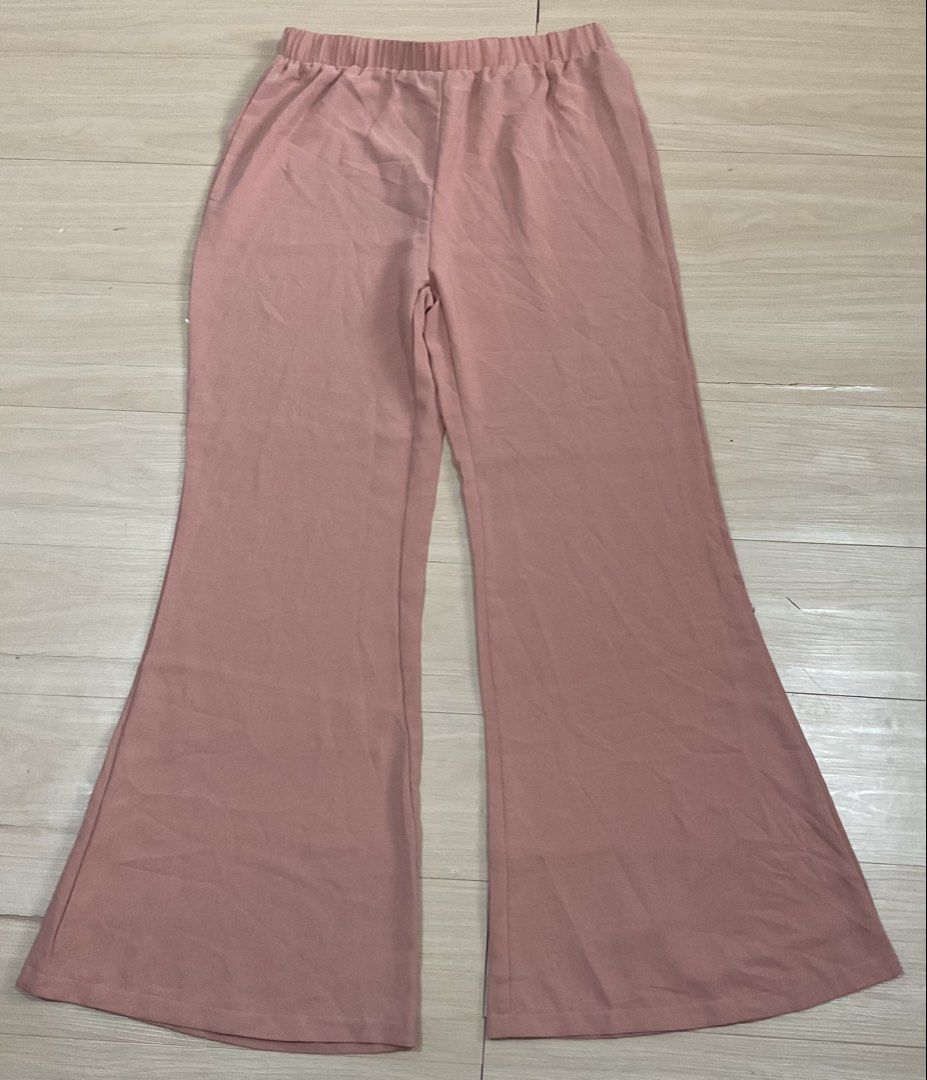 SHEIN Pink Bell Bottom Pants Size L (Category: Jeans) located in Makati City. Submitted by slickthingsph (Listing ID 1452028225, Image 1). Description: - Pink bell bottom pants from SHEIN - Comfortable elastic waistband - Size L - Made in China - Versatile for casual or dressed-up outfits.