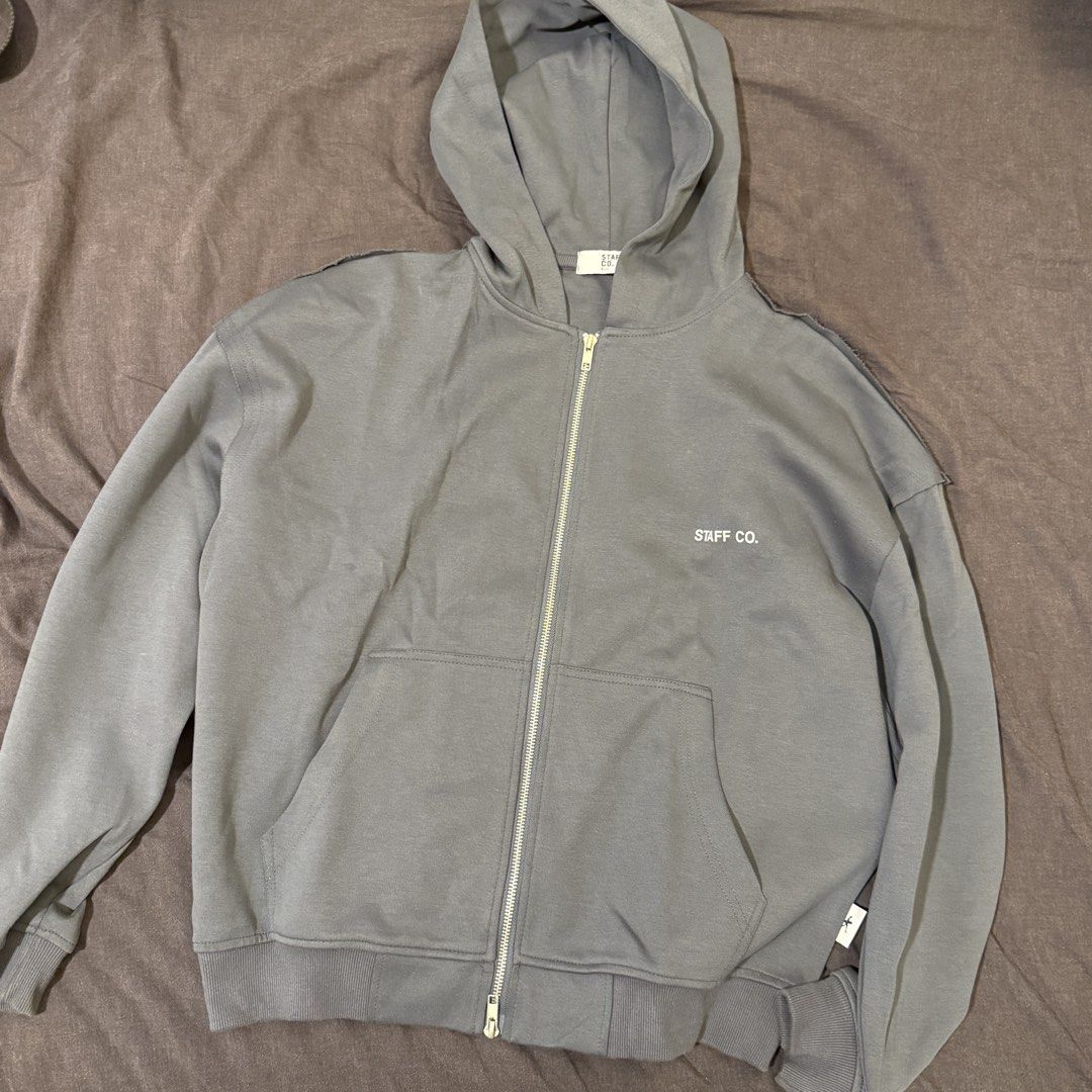 Staff Co. Grey Zip-Up Hoodie (Category: Coats, Jackets and Outerwear) located in Manila. Submitted by jpumpa (Listing ID 1452047656, Image 1). Description: - Grey zip-up hoodie from Staff Co. - Features Staff Co. logo on front and back - Comfortable fit - Ideal for casual wear.