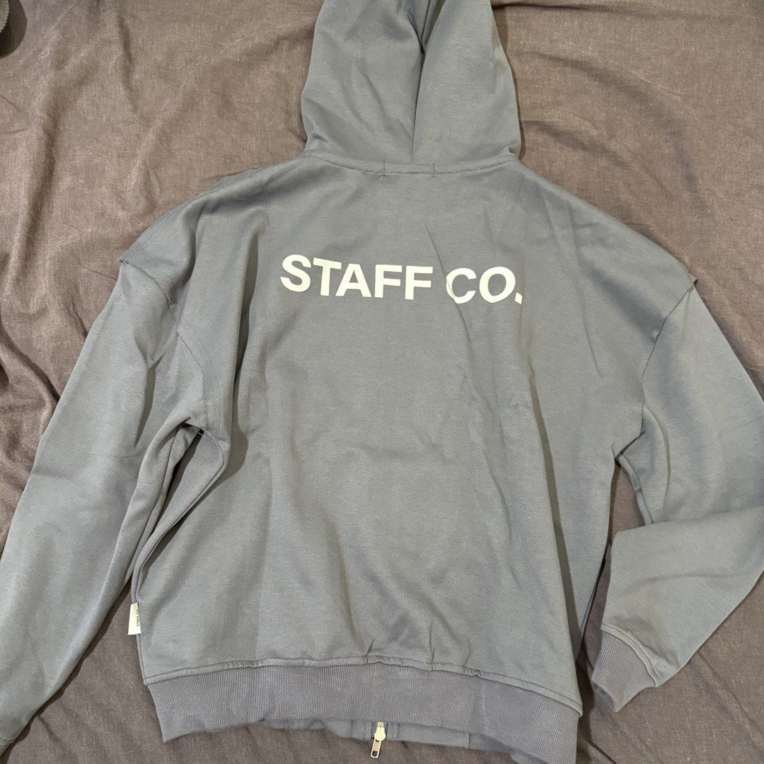 Staff Co. Grey Zip-Up Hoodie (Category: Coats, Jackets and Outerwear) located in Manila. Submitted by jpumpa (Listing ID 1452047656, Image 2). Description: - Grey zip-up hoodie from Staff Co. - Features Staff Co. logo on front and back - Comfortable fit - Ideal for casual wear.