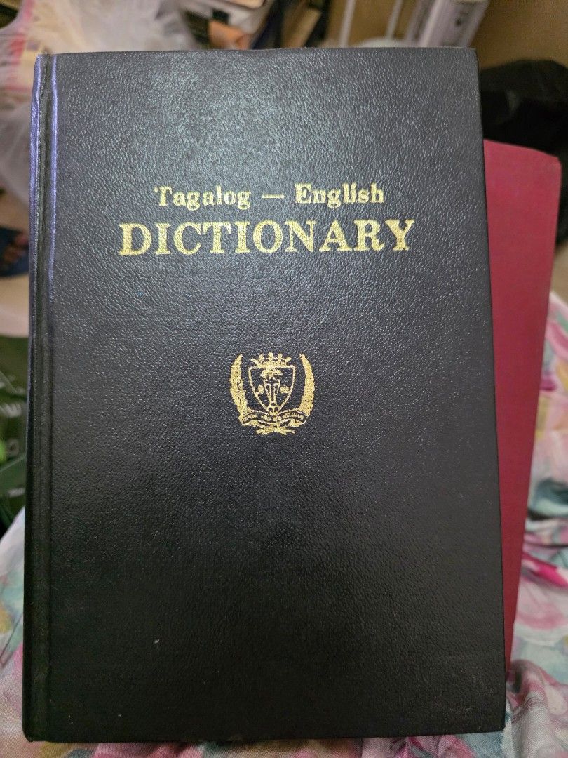 Tagalog - English Dictionary (Category: Textbooks) located in Makati City. Submitted by clearbrilliantjade (Listing ID 1452095532, Image 1). Description: - Hardbound Tagalog-English Dictionary - Elegant black cover with gold lettering - Features a distinguished crest on the front - Ideal for language learners - Excellent reference for students and professionals.