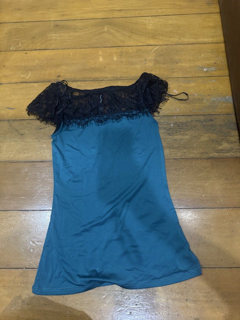 Teal Lace Off-Shoulder Top (Category: Blouses) located in Las Pinas. Submitted by katfg (Listing ID 1451954614, Image 1). Description: - Teal off-shoulder top - Black lace trim around neckline and down the front - Ruffled sleeves - Thin adjustable straps - Estimated size: Small to Medium - Versatile for night out or casual occasions.