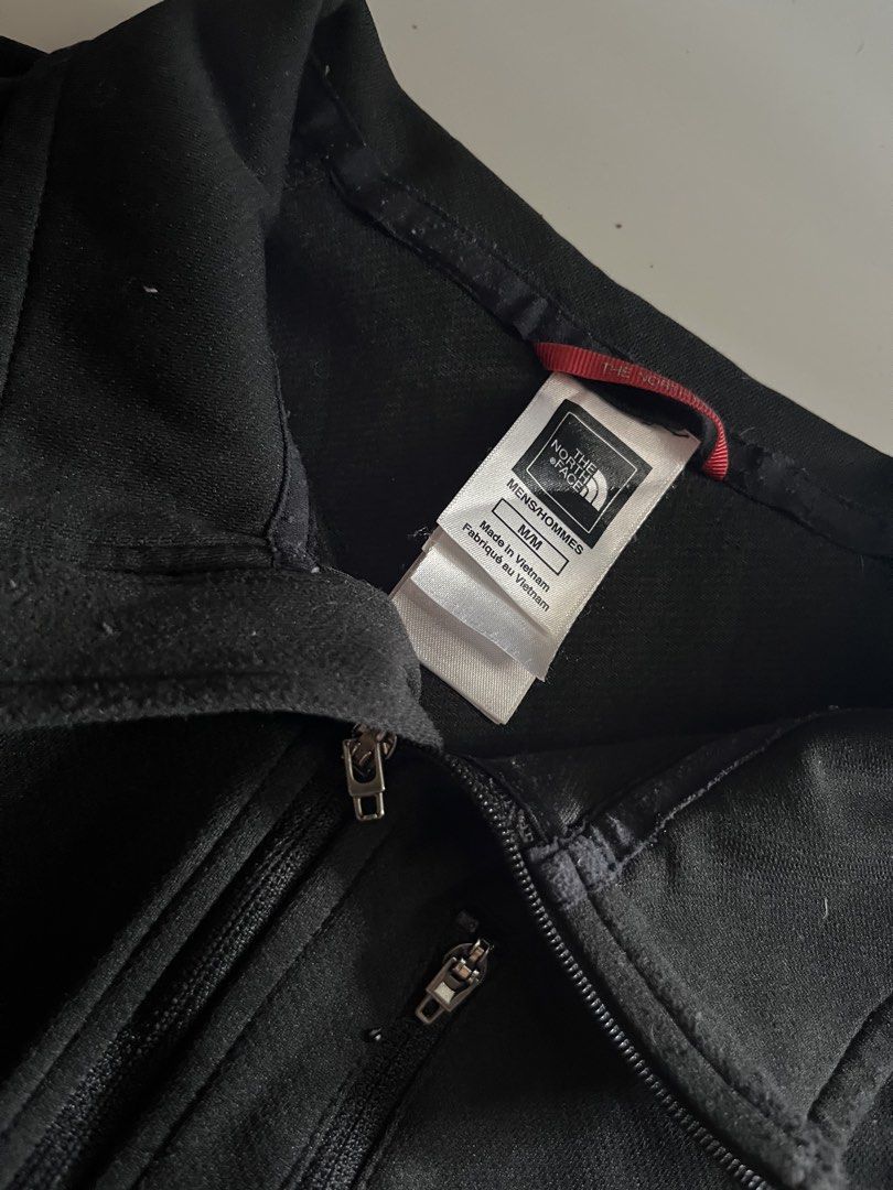 The North Face Track Jacket (Category: Coats, Jackets and Outerwear) located in Santa Ana. Submitted by rlave (Listing ID 1452003606, Image 3). Description: Preloved The North Face black full-zip jacket, size M, men’s fit. Features the embossed North Face logo on the chest, mock collar, zippered chest and side pockets, and mesh-lined side panels for breathability. Comfortable technical fit — great for outdoor use, layering, or everyday cooler-wea