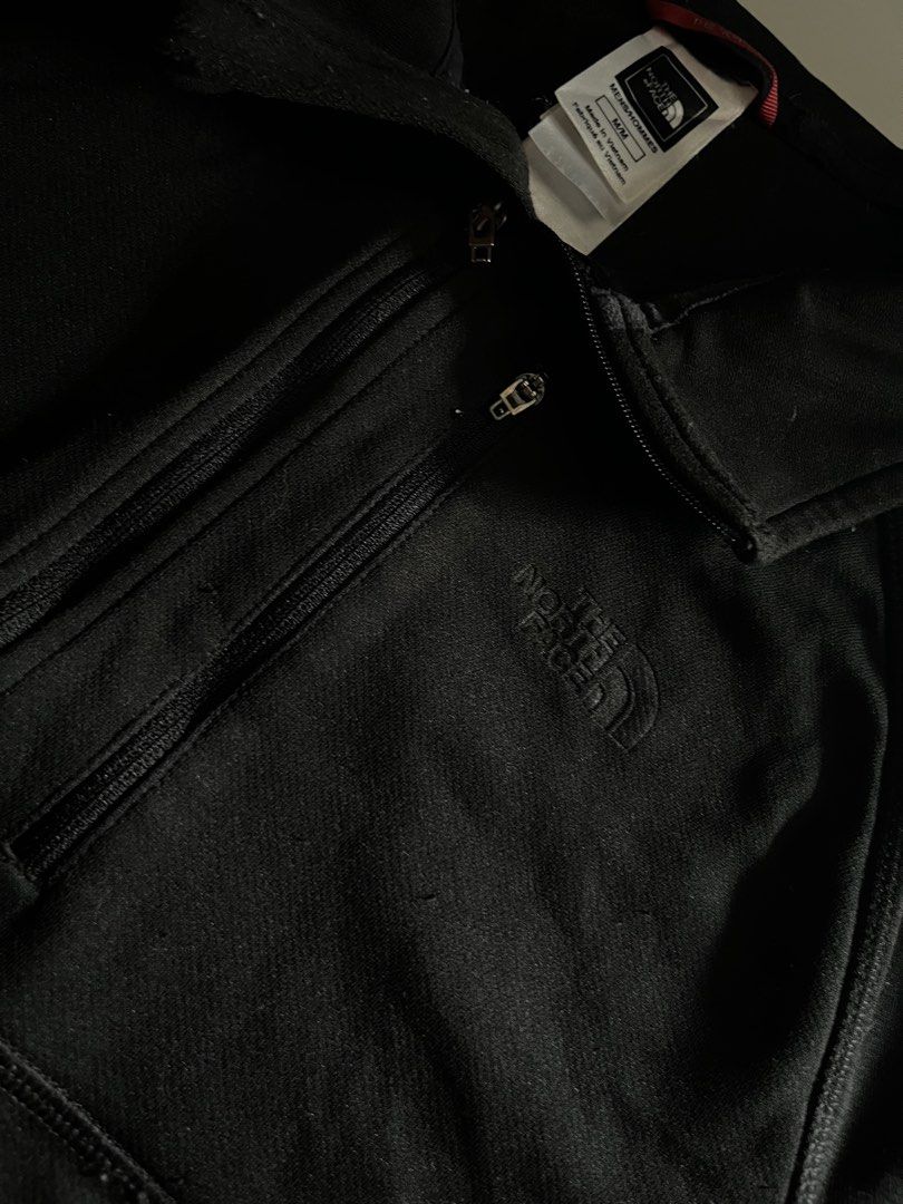 The North Face Track Jacket (Category: Coats, Jackets and Outerwear) located in Santa Ana. Submitted by rlave (Listing ID 1452003606, Image 2). Description: Preloved The North Face black full-zip jacket, size M, men’s fit. Features the embossed North Face logo on the chest, mock collar, zippered chest and side pockets, and mesh-lined side panels for breathability. Comfortable technical fit — great for outdoor use, layering, or everyday cooler-wea
