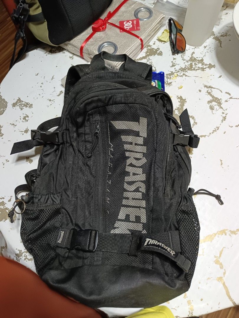 Thrasher Magazine Mesh pocket Skate Backpack Black (Category: Backpacks) located in Butuan. Submitted by sinaliky (Listing ID 1452050135, Image 3). Description: - Classic Black Thrasher backpack - Features iconic Thrasher logo on the front - Multiple pockets and compartments for ample storage - Adjustable straps for a comfortable fit - Perfect for school, travel, or everyday use - Shows some signs of wear, but remains in good, functional conditio
