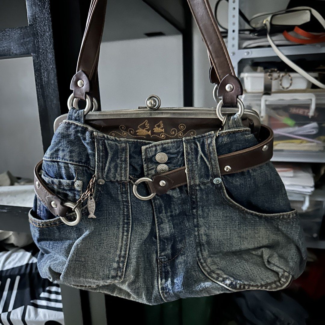 Unique Denim Handbag with Brown Leather Accents (Category: Luxury Bags & Wallets) located in Manila. Submitted by drewtj (Listing ID 1452091969, Image 1). Description: can fit 11” ipad - Cool denim handbag with a vintage vibe - Features brown leather straps and belt detail - Secure kiss-lock closure - Adorable fish charm attached - Plenty of space inside for your essentials - Ideal for casual outings.