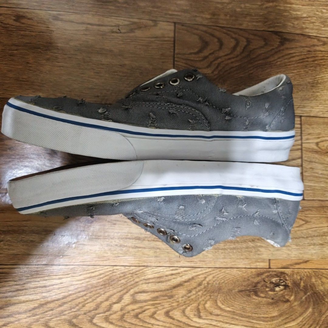 Vans Era Grey Distressed Canvas Skate Shoes (Category: Sneakers) located in Manila. Submitted by narju1234 (Listing ID 1452044192, Image 2). Description: - Grey Vans Era skate shoes - Distressed, ripped canvas material - Classic white rubber sole with blue stripe detail - Lace-up closure - Soles show wear but have plenty of grip - Perfect for everyday wear or skating size 9 and 10 available.