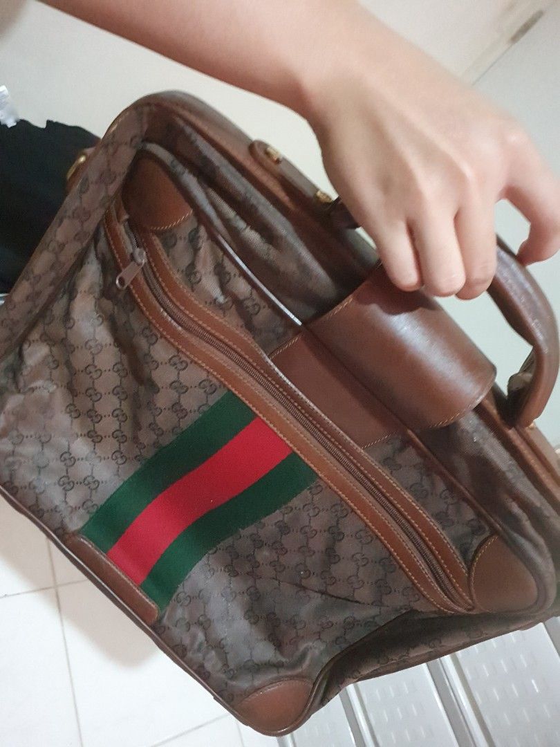 Vintage Gucci Monogram Briefcase (Category: Luxury Bags & Wallets) located in Quezon City. Submitted by montemayordarleen (Listing ID 1451969481, Image 1). Description: - Classic Gucci monogram briefcase - Color: Brown GG canvas with leather trim - Iconic green and red stripe detail - Spacious and lined interior - Sturdy handle - Functional zippers - Ideal for work or travel.