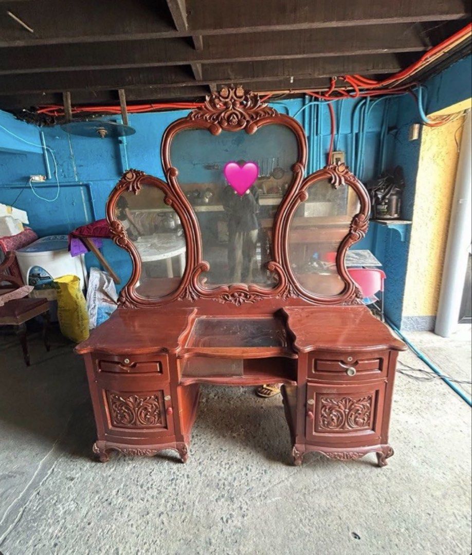 Vintage Narra Wooden Dressing Table with Tri-Fold Mirror (Category: Tables & Sets) located in Manila. Submitted by shiee (Listing ID 1452072948, Image 1). Description: - Wooden dressing table - Large central mirror with two side mirrors - Ornate carvings on drawers and frame - Plenty of storage space (drawers and shelves) - Beautiful bedroom piece - Shows some wear and tear on the surface - RFS : space for my gym equipment .