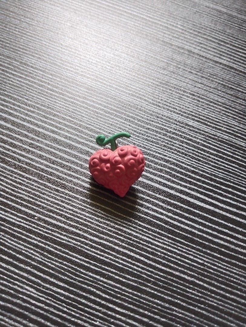 Vintage One Piece Ope Ope no Mi Devil Fruit Keychain (Category: Character Goods) located in Quezon City. Submitted by osaki.drew (Listing ID 1448013618, Image 2). Description: - Ope Ope No Mi charm - Small, red, heart-shaped design - Comes with original capsule and paper insert - Ideal for One Piece fans and collectors.