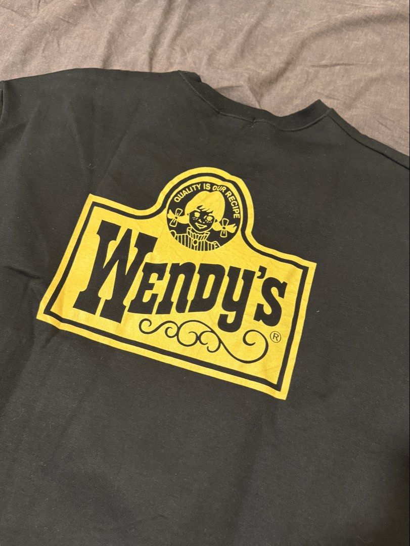 Wendy's Black Crewneck Sweatshirt (Category: Coats, Jackets and Outerwear) located in Manila. Submitted by jpumpa (Listing ID 1452048633, Image 2). Description: - Black crewneck sweatshirt - Features Wendy's logo on front and back - Back design includes classic Wendy's logo and "Quality is Our Recipe" - Cozy and casual style - Ideal for everyday wear - A must-have for any Wendy's fan.