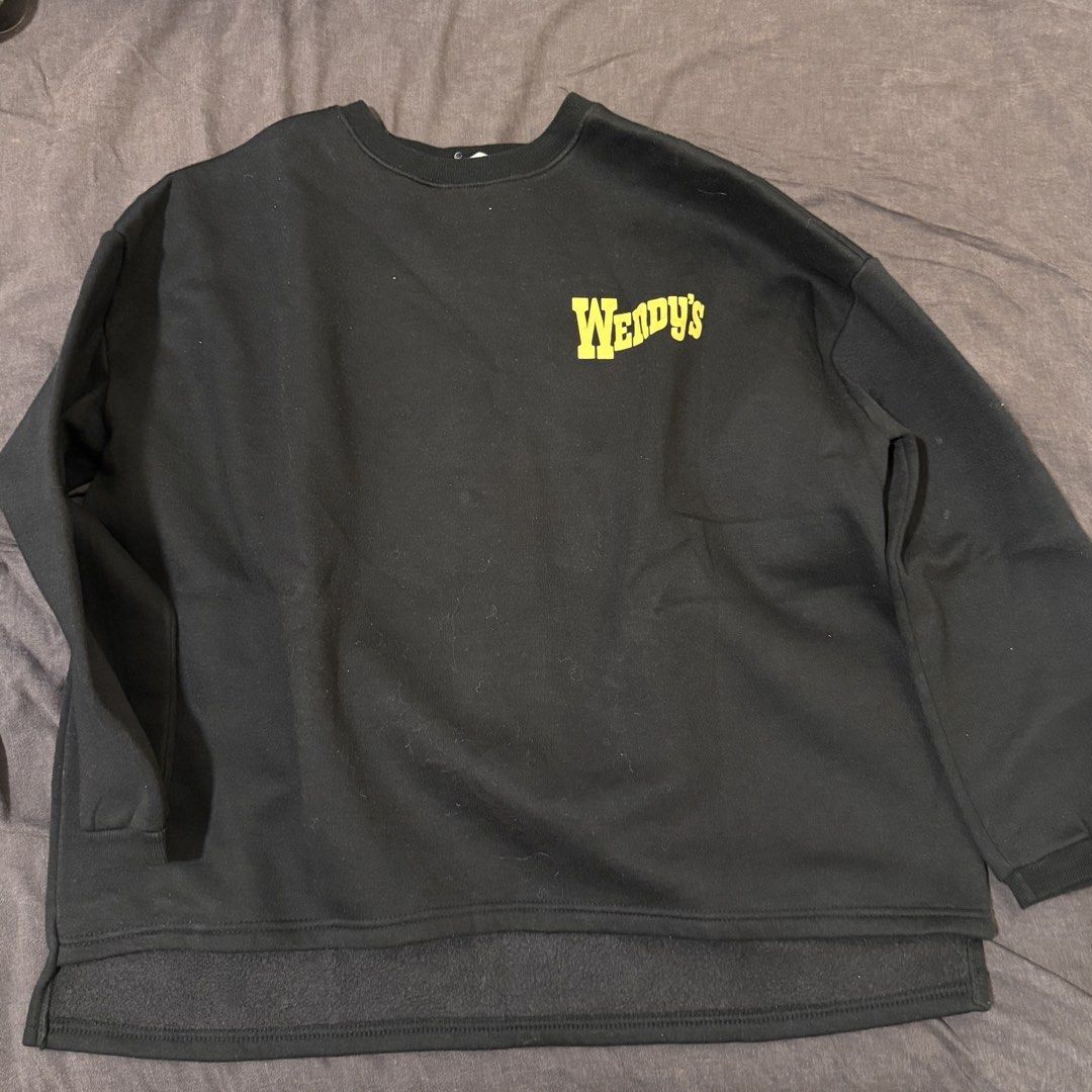 Wendy's Black Crewneck Sweatshirt (Category: Coats, Jackets and Outerwear) located in Manila. Submitted by jpumpa (Listing ID 1452048633, Image 1). Description: - Black crewneck sweatshirt - Features Wendy's logo on front and back - Back design includes classic Wendy's logo and "Quality is Our Recipe" - Cozy and casual style - Ideal for everyday wear - A must-have for any Wendy's fan.