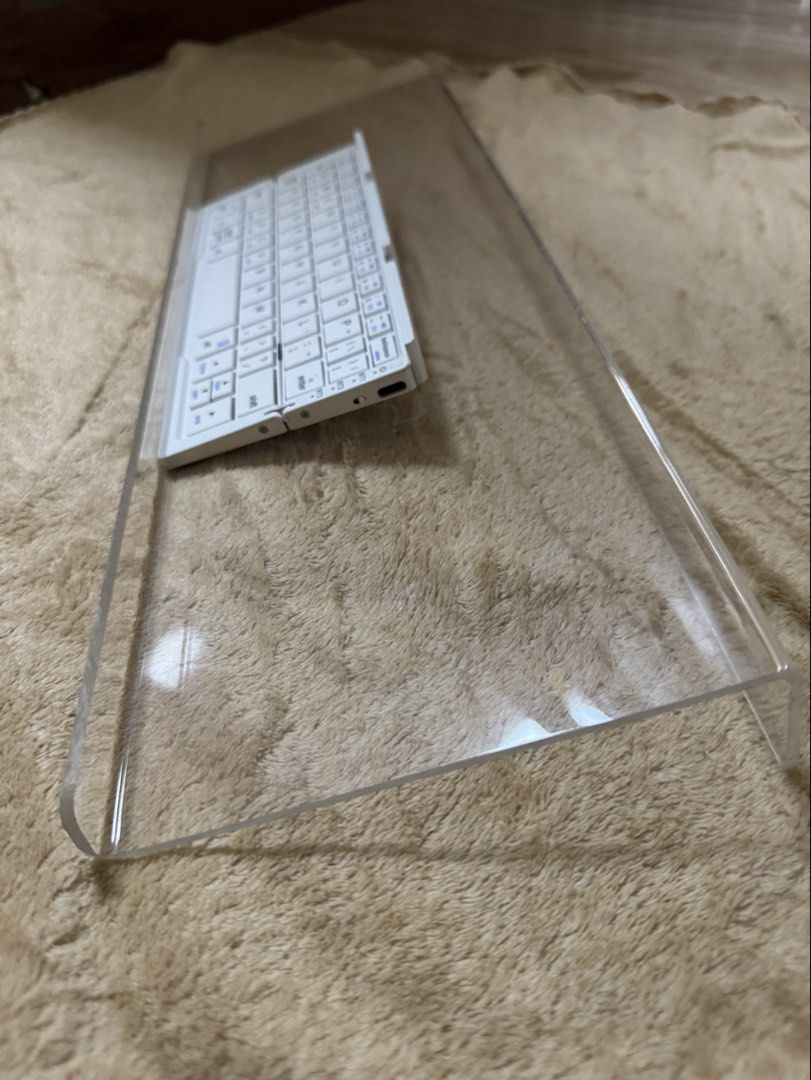 WFH Keyboard Clear Acrylic Stand (Category: Computer Keyboard) located in Manila. Submitted by averythingg (Listing ID 1451925719, Image 3). Description: - Clear acrylic riser stand - Dimensions: Approx. 12 inches long x 6 inches wide - Ideal for WFH setups, displaying books, keyboards, small plants, and other items - For minimalist peeps.