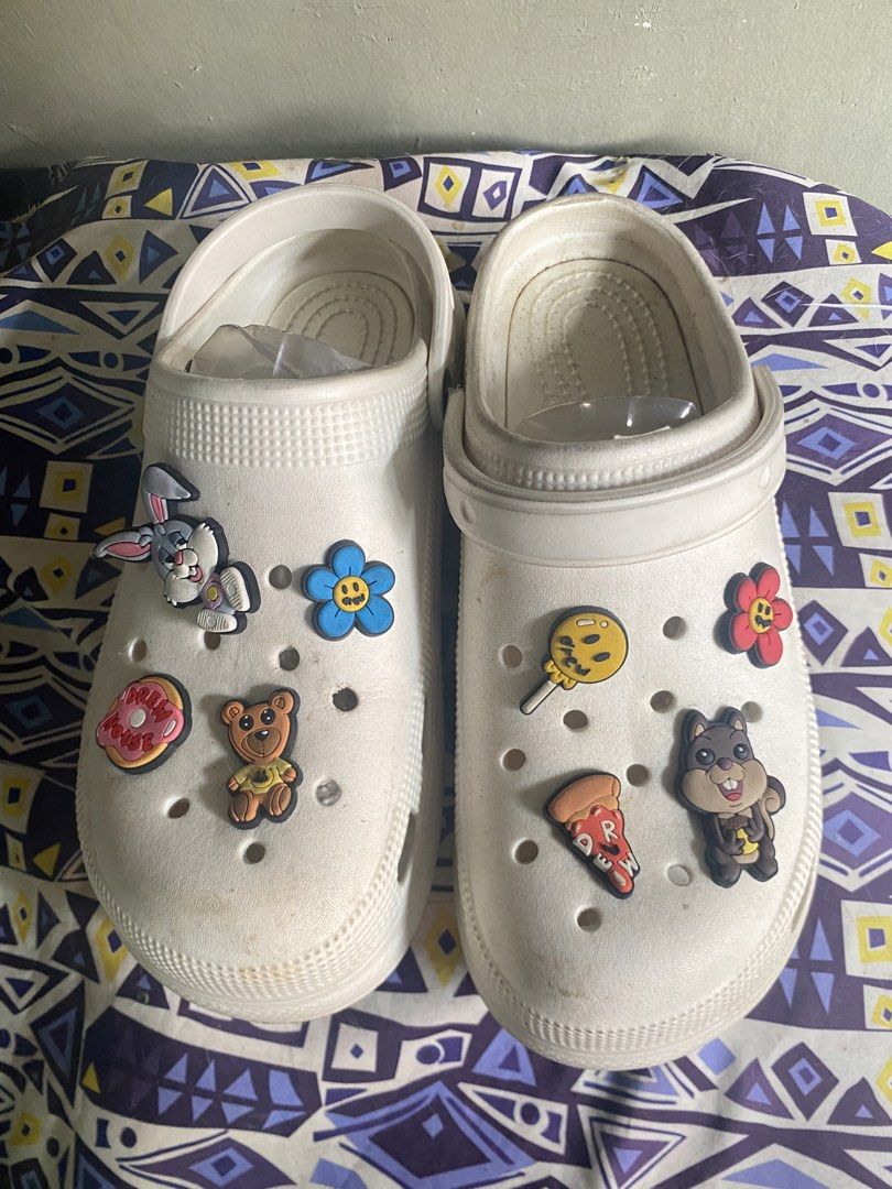 White Crocs with Cute Charms Size 39 (Category: Slippers and slides) located in Marikina City. Submitted by lanceflordeliz (Listing ID 1451912092, Image 1). Description: - White Crocs - Size 39 - Decorated with fun charms (bunny, donut, teddy bear, lollipop, pizza, and more) - Easy slip-on and off design - Soles show some signs of wear - Ideal for casual wear.