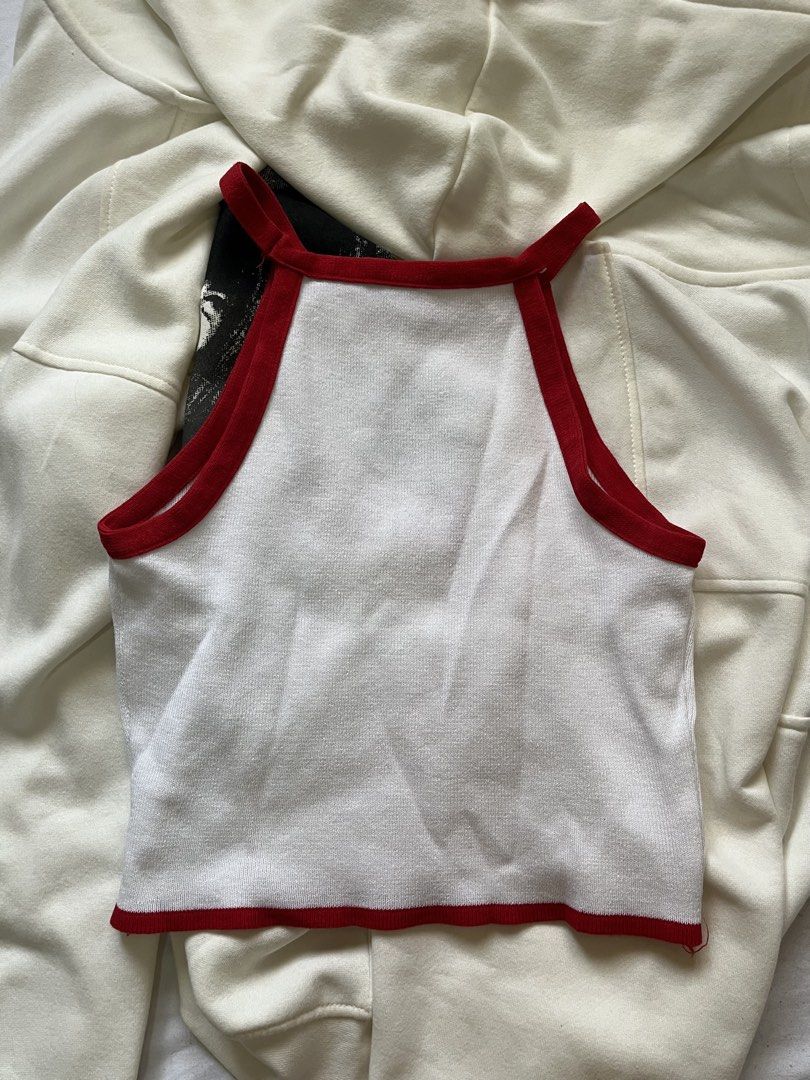 White Teddy Bear Embroidered Crop Top with Red Trim (Category: Others Tops) located in Paranaque City. Submitted by bymuse.co (Listing ID 1452008677, Image 3). Description: - Adorable white crop top - Features a cute teddy bear embroidery with 'is something YOU MAKE' text - Stylish red trim along the neckline and hem - Sleeveless halter design - Perfect for casual outfits or layering - Fits like a size Small.