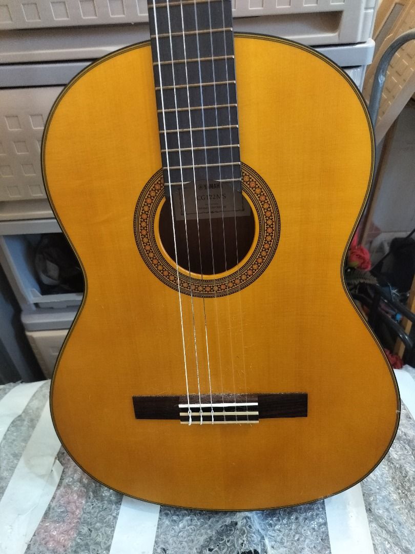 Yamaha Classical Guitar (Category: Musical Instruments) located in Mandaluyong City. Submitted by tom200599 (Listing ID 1452094731, Image 1). Description: - Yamaha classical guitar - Natural wood finish - Nylon strings - Dark fretboard - Round body shape - Darker wood back and sides - Minor cosmetic imperfections I've had it for a year, only been played about 10-12 hours. It's just sitting here at the side of my piano. I'm selling it due to not r