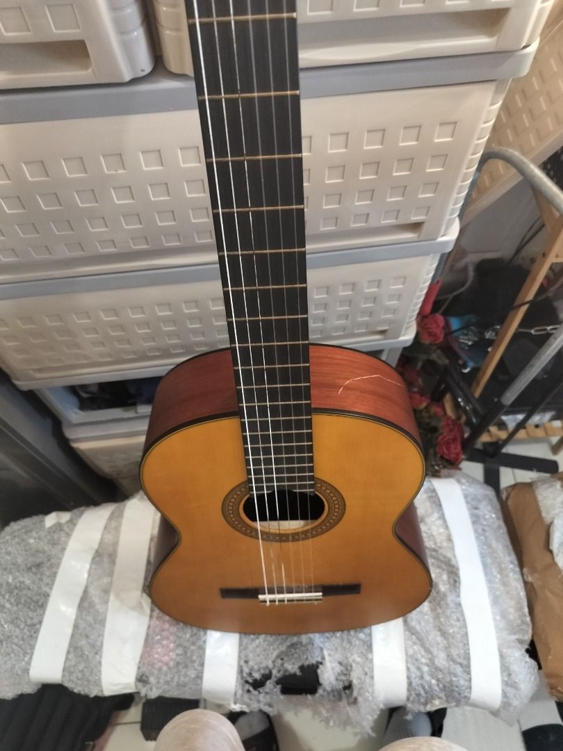 Yamaha Classical Guitar (Category: Musical Instruments) located in Mandaluyong City. Submitted by tom200599 (Listing ID 1452094731, Image 2). Description: - Yamaha classical guitar - Natural wood finish - Nylon strings - Dark fretboard - Round body shape - Darker wood back and sides - Minor cosmetic imperfections I've had it for a year, only been played about 10-12 hours. It's just sitting here at the side of my piano. I'm selling it due to not r