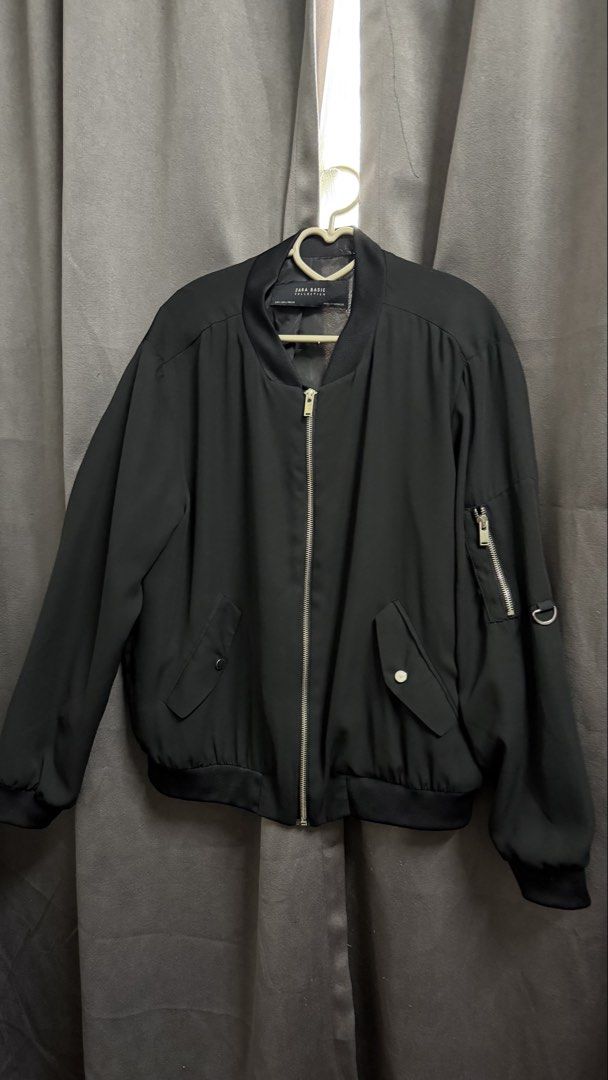 Zara Basic Collection Black Bomber Jacket (Category: Coats, Jackets and Outerwear) located in Kuala Lumpur. Submitted by fa2005t (Listing ID 1452004178, Image 1). Description: - Classic black bomber jacket from Zara Basic Collection. - Zip-up front closure. - Convenient side pockets. - Zippered pocket on the sleeve. - Ribbed cuffs and hem for a snug fit. - Perfect for layering and easy to style with any outfit..