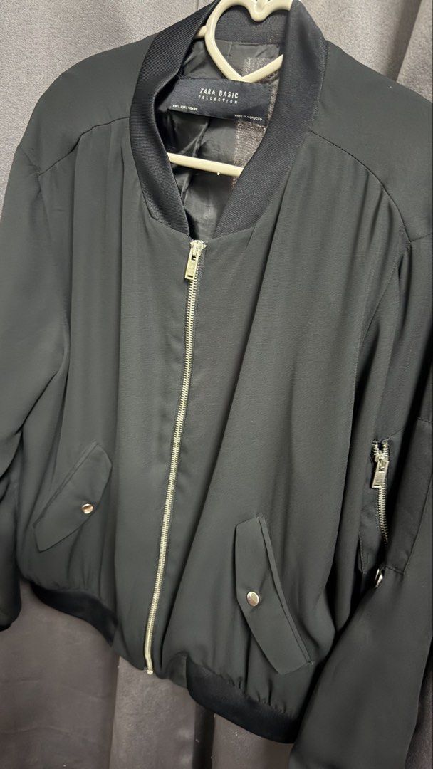 Zara Basic Collection Black Bomber Jacket (Category: Coats, Jackets and Outerwear) located in Kuala Lumpur. Submitted by fa2005t (Listing ID 1452004178, Image 3). Description: - Classic black bomber jacket from Zara Basic Collection. - Zip-up front closure. - Convenient side pockets. - Zippered pocket on the sleeve. - Ribbed cuffs and hem for a snug fit. - Perfect for layering and easy to style with any outfit..