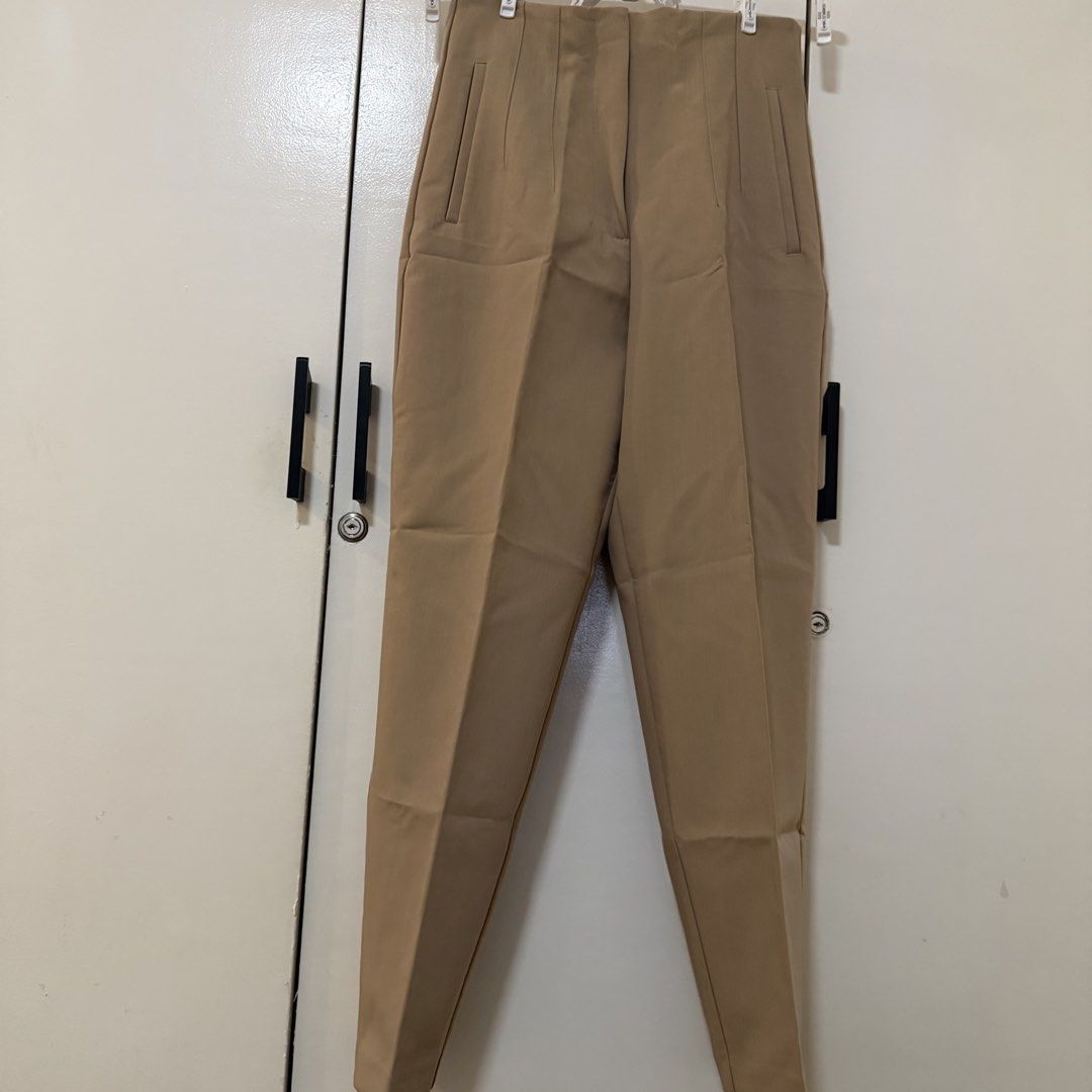 ZARA Tan High Waisted Tailored Pants Size S (Category: Other Bottoms) located in Bulacan. Submitted by declutter_diary02 (Listing ID 1451949952, Image 3). Description: - UNUSED (fitted only) - Zara tailored pants - High-waisted fit - Straight leg cut - Front pockets - Zipper and button closure - Made in Turkey - Size S - Ideal for work or casual outfits PLEASE READ ‼️ MOP: Gcash or Bank transfer MOD: Lalamove/Grab or J&T (pickup only) Pickup time