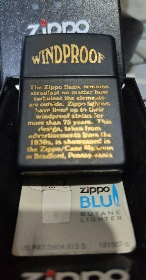 SWAP/SALE Zippo Windproof Butane Lighter - AUTHENTIC (Category: Hiking & Camping) located in Manila. Submitted by karuselkoh (Listing ID 1451927199, Image 3). Description: - Zippo butane lighter - Classic black finish with gold 'Windproof' design - Back features text about Zippo flame history - Made in USA - Includes original box AUTHENTIC 100% OFFER LANG KUNG SWAP.