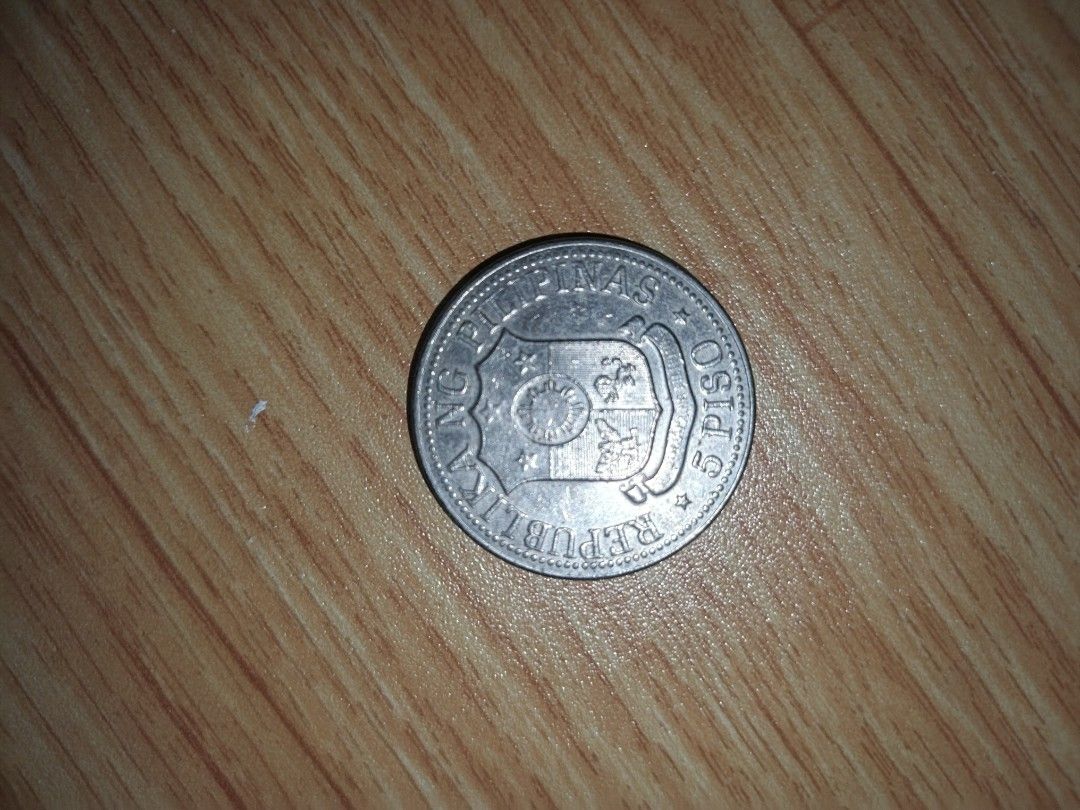 1975 Philippines 5 Piso Coin ft. Ferdinand E. Marcos (Category: Currency) located in Naga. Submitted by esteemed_shop (Listing ID 1452198928, Image 2). Description: - 1975 Philippine 5 Peso coin - Features Ferdinand E. Marcos profile - Reverse side displays the Philippine coat of arms - Ideal addition for coin collectors.