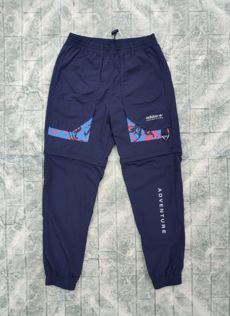 Adidas ADV Convertible Pants - Navy Blue (Category: Joggers) located in Bayambang. Submitted by mon10192816 (Listing ID 1452223404, Image 2). Description: - Waist 30-35 - Length 41 - Issue Loose Stitch check last photo - Adidas ADV convertible pants - Color: Navy blue - Zips off to convert into shorts - Features graphic details on the sides - Elastic waistband with adjustable drawstring - pockets on the back - Ideal for hiking and outdoor activit