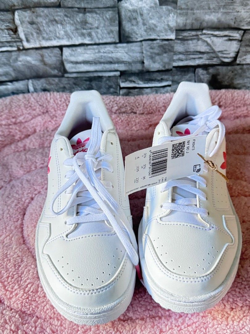 Adidas White Pink Logo Sneakers (Category: Sneakers) located in Santa Rosa. Submitted by amiraamara (Listing ID 1452114089, Image 3). Description: - White Adidas sneakers with stylish pink accents. - Features iconic Adidas logo on the side and heel. - Classic lace-up closure for a secure fit. - Incredibly clean and fresh condition. - Ideal for everyday casual wear. - Comes with original tags attached. -No Box pasalubong from dubai,too small for m