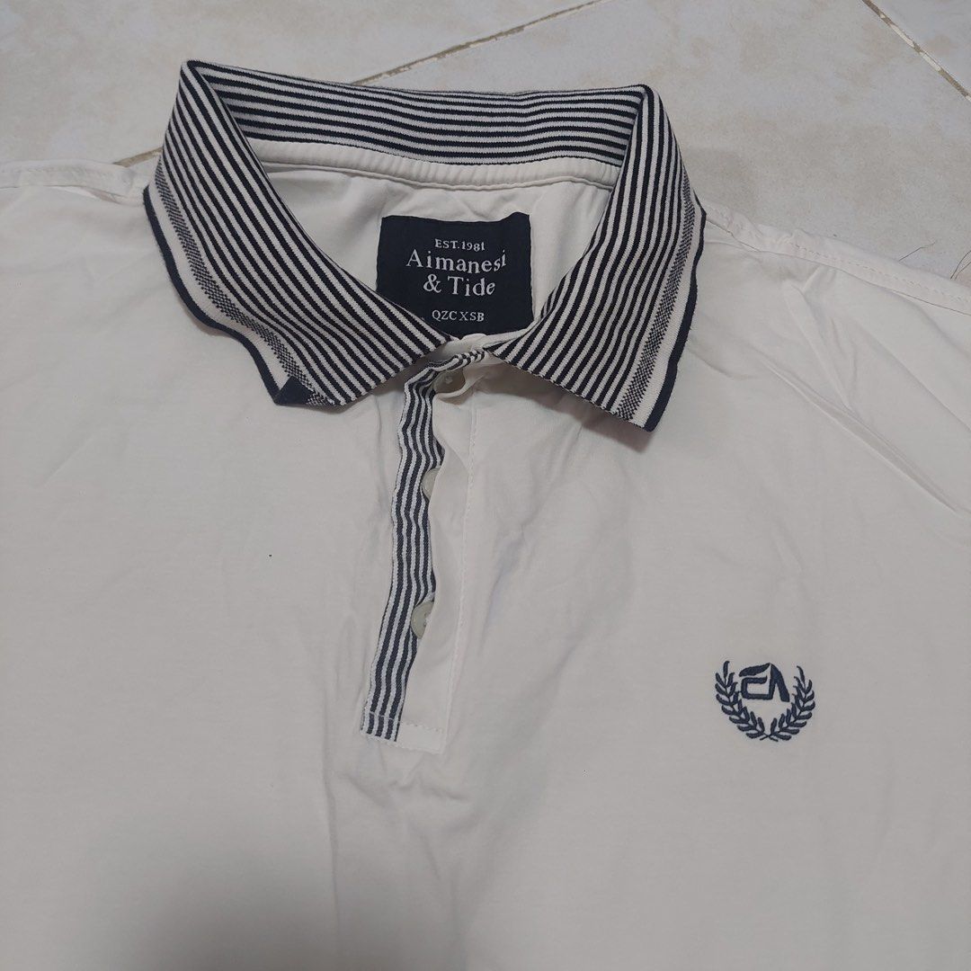 AIMANSEI & TIDE 3XL White Polo Shirt (Category: Tshirts & Polo Shirts ) located in Quezon City. Submitted by _ysxh (Listing ID 1452140258, Image 3). Description: - Brand: AIMANSEI & TIDE - Color: White - Size: 3XL - Measurements: Width 57.5 cm, Length 69.5 cm - Features: Classic collar with striped detail, small embroidered chest logo, striped sleeve cuffs - Style: Casual wear - Shipping to be shouldered by buyer (Item is located in Quezon City) 