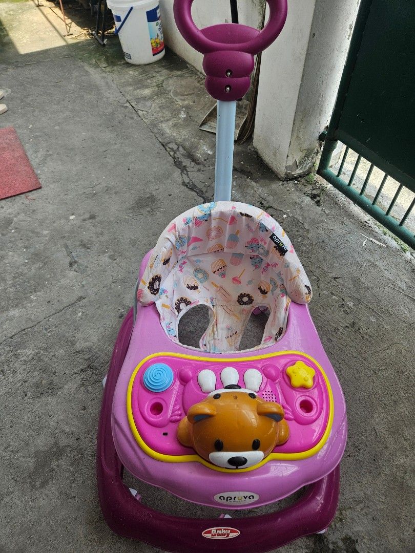 Apruva Baby Walker with Bear Toy (Category: Infant Playtime) located in Quezon City. Submitted by marco.luces23 (Listing ID 1452149272, Image 3). Description: Pink baby walker with a cute bear toy on the front. Bought last december for 2199php in baby company. Has a padded seat and a push handle. Wheels are intact. Some scuff marks on the frame. Ready for a new little walker! issues: needs cleaning and wala na yung accessory toy. wala na din yung