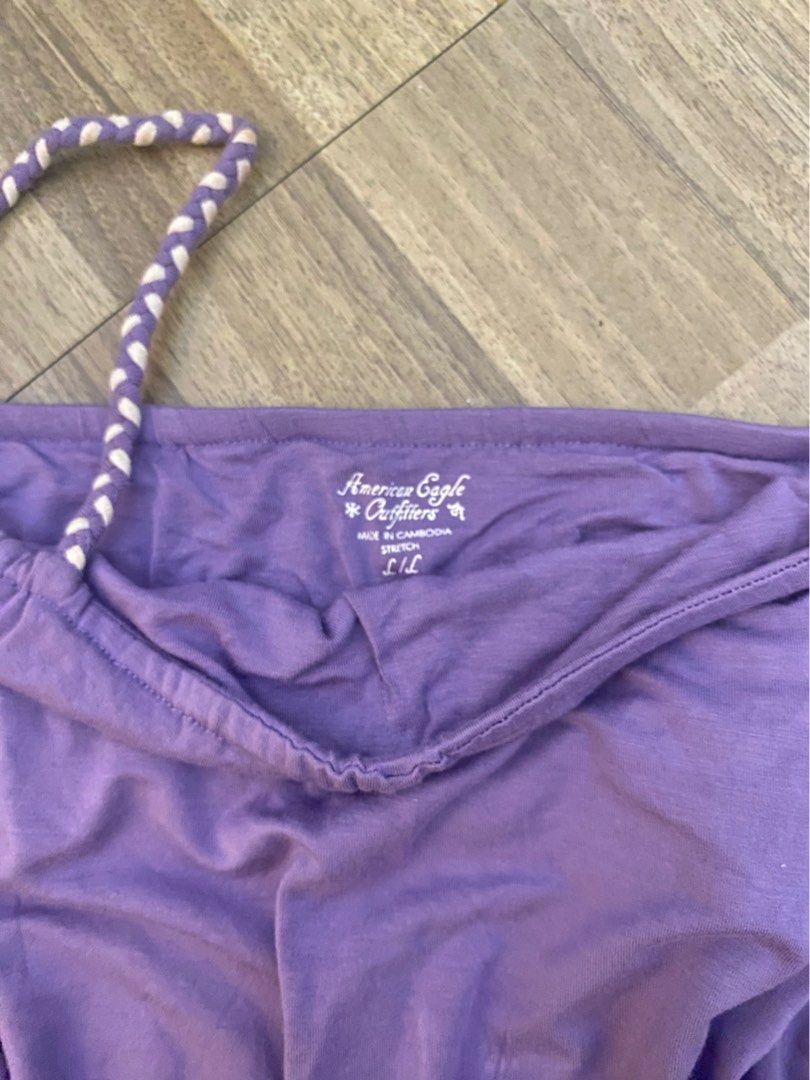 Authentic American Eagle Purple Spaghetti Strap Tank Top (Category: Sleeveless) located in Manila. Submitted by larajaysong (Listing ID 1452260202, Image 2). Description: - Cute purple tank top from American Eagle - Braided spaghetti straps - Ruffled hem - Stretchy and comfortable fabric - Perfect for casual wear or layering - Size: Large (L).
