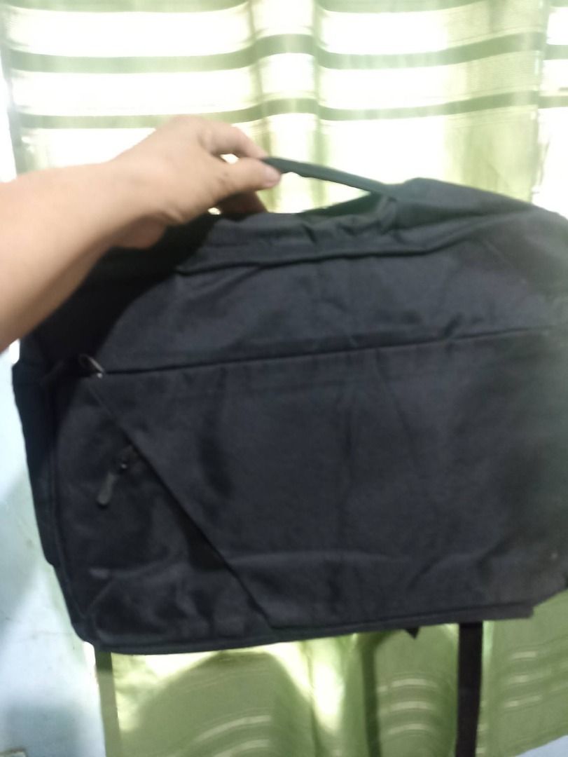 Black Laptop Bag with Handle (Category: Luxury Bags & Wallets) located in Marilao. Submitted by ofeliasto99258 (Listing ID 1452228922, Image 1). Description: Durable black bag, perfect for work or school. Features a top handle, front zip pocket, and ample interior space..