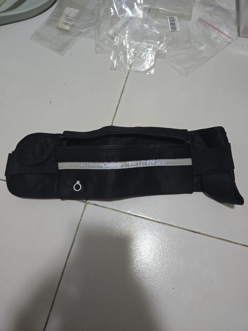 Black Running Waist Bag with Reflective Strip (Category: Belt bags, Clutches and Pouches) located in Pasig City. Submitted by callmemaf (Listing ID 1452184738, Image 1). Description: - FREE FOR ANY PURCHASE ABOVE 250 - Zipper stuck - Black waist bag perfect for running or cycling. - Features a secure zippered compartment for your essentials. - Includes a reflective strip for enhanced visibility during night activities. - Adjustable strap with a b