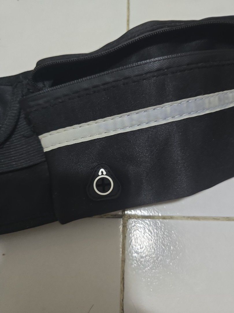 Black Running Waist Bag with Reflective Strip (Category: Belt bags, Clutches and Pouches) located in Pasig City. Submitted by callmemaf (Listing ID 1452184738, Image 2). Description: - FREE FOR ANY PURCHASE ABOVE 250 - Zipper stuck - Black waist bag perfect for running or cycling. - Features a secure zippered compartment for your essentials. - Includes a reflective strip for enhanced visibility during night activities. - Adjustable strap with a b