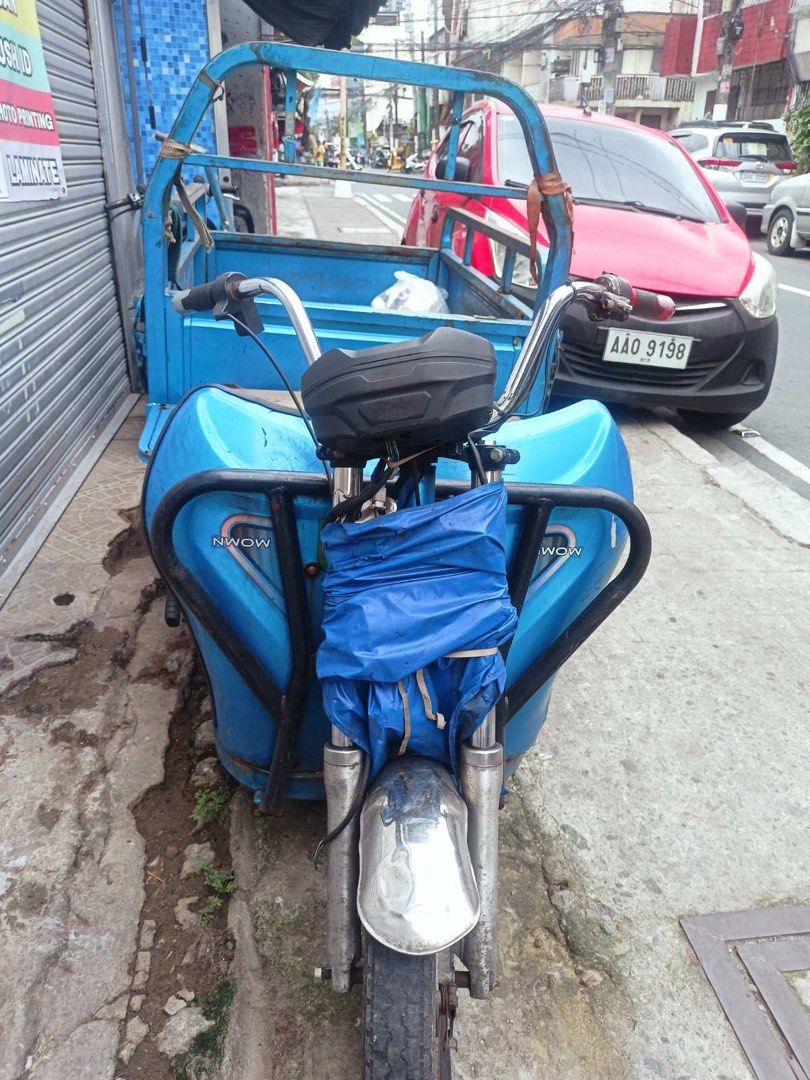 Blue Tricycle with Cargo Bed (Category: Motorbikes for Sale) located in Manila. Submitted by mschasaha60513 (Listing ID 1452242143, Image 1). Description: Selling a blue tricycle. It has a cargo bed at the back. The front is covered with a blue tarp. The handlebars are silver. It's a three-wheeled vehicle. .