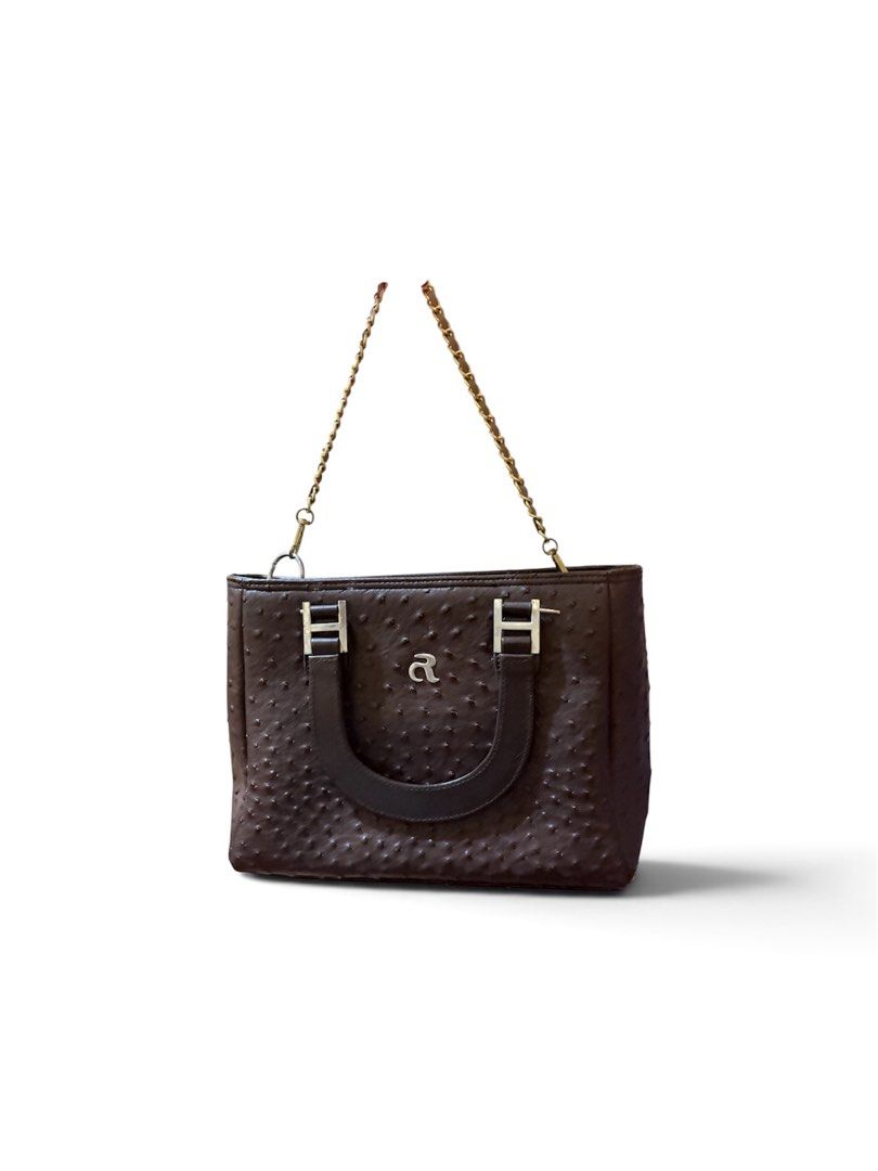 Brown Ostrich Embossed Handbag with Chain Strap (Category: Luxury Bags & Wallets) located in Manila. Submitted by y2k_angels (Listing ID 1452260590, Image 1). Description: - Stylish brown handbag with a luxurious ostrich-embossed texture. - Features a comfortable curved top handle for easy carrying. - Includes a detachable gold-tone chain strap for versatile styling. - Subtle 'a' logo on the front adds a touch of elegance. - Spacious interior, id