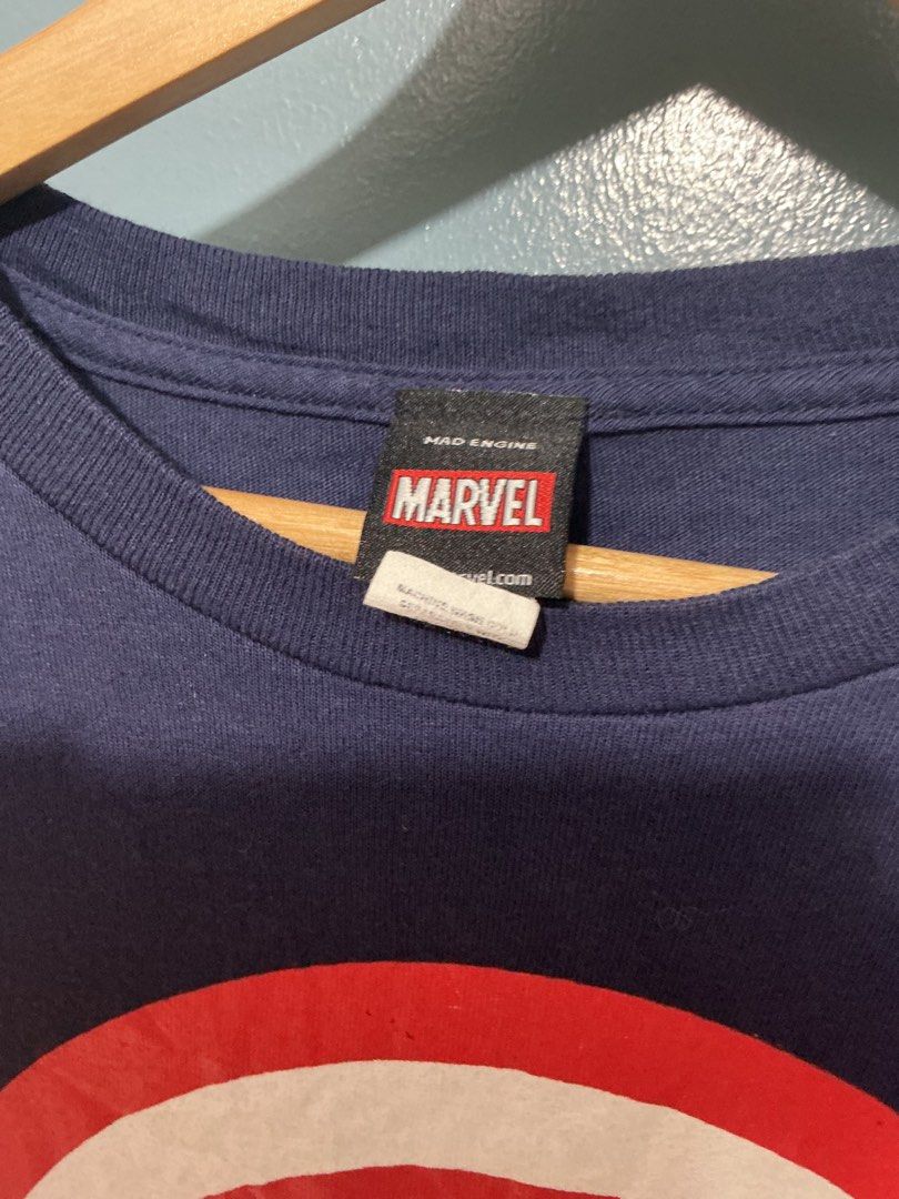 Captain America Mad Engine (Category: Tshirts & Polo Shirts ) located in Bulacan. Submitted by garmentsbyadi. (Listing ID 1452241730, Image 3). Description: - Captain America Shield Design - Hardtag Mad Engine 2012 Length: 30 Width: 23 23x30 - Large to XL Condition: 9.5 Color rate: 9.5 (Color may vary due to lighting).